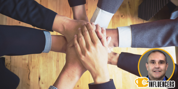 Hands together in union with John Keneny’s headshot in the bottom right corner
