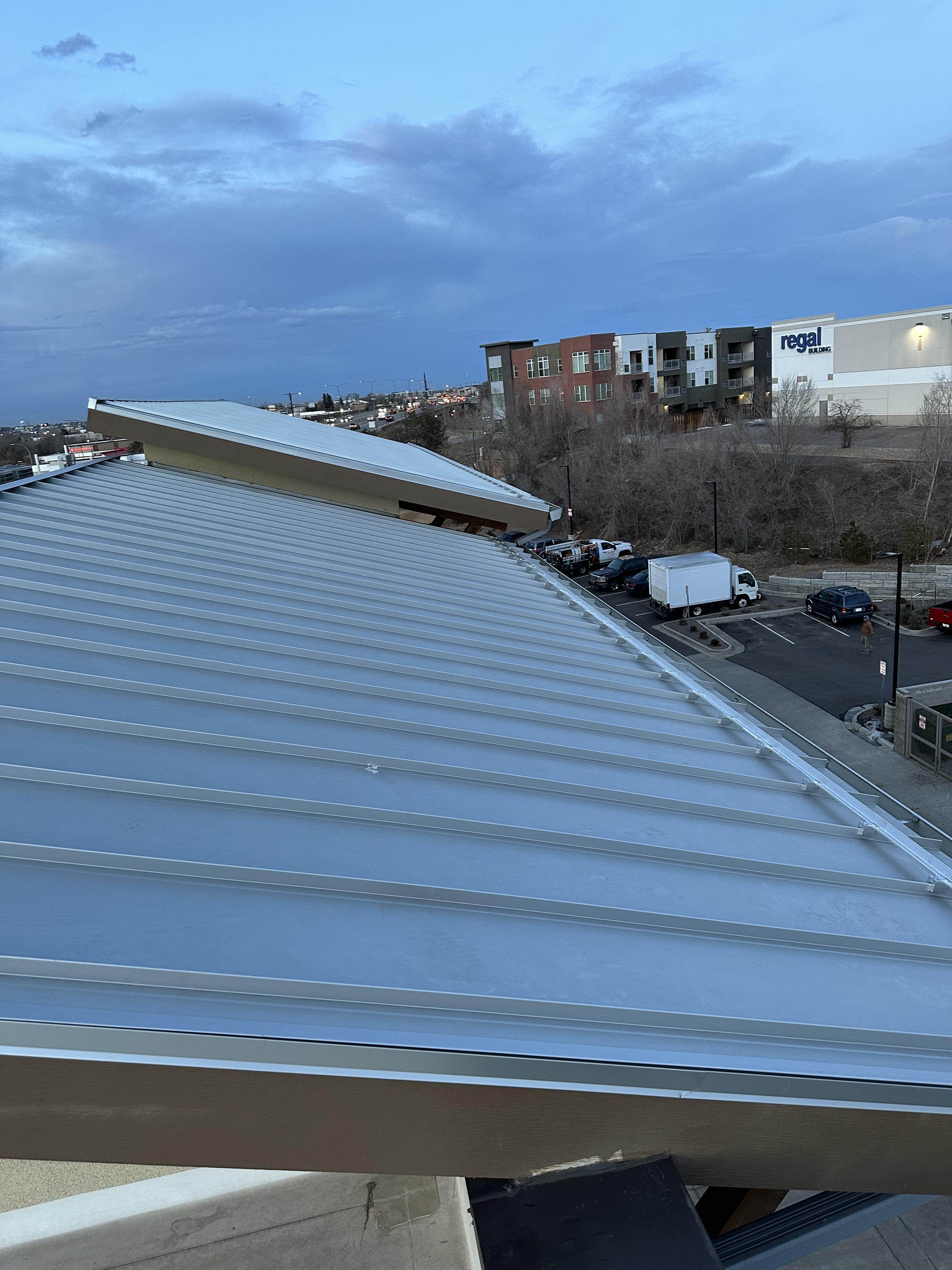 Rocky Mountain - S-5! ColorGard with S-5! S Clamps and evergreen color strips on metal snap lock roof on the WoodSprings Suites Hote
