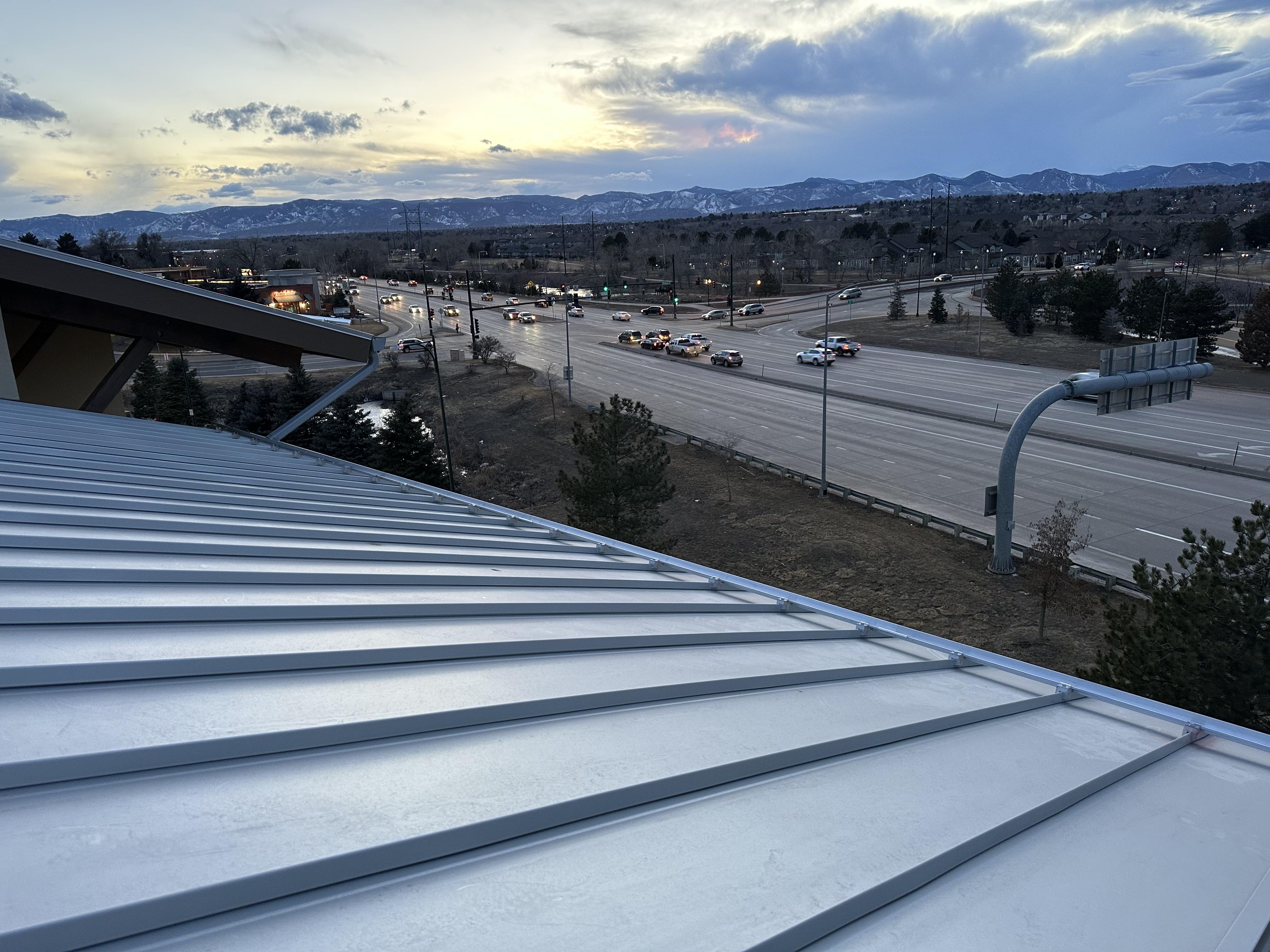 Rocky Mountain - S-5! ColorGard with S-5! S Clamps and evergreen color strips on metal snap lock roof on the WoodSprings Suites Hotel